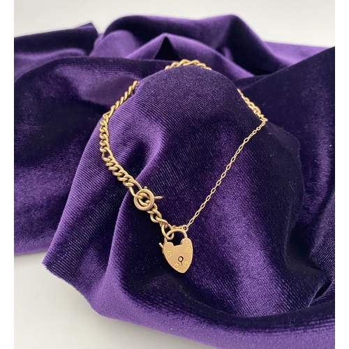 157 - A 9CT GOLD HEART LOCK PENDANT BRACELET, Figaro chain link bracelet, with heart lock pendant hallmark... 