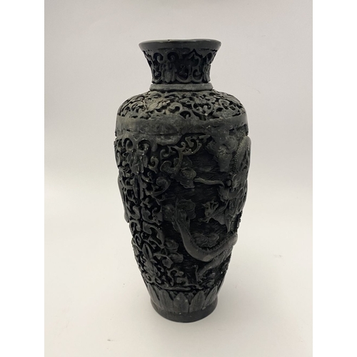 91 - A CHINESE CARVED BLACK CINNABAR LACQUER VASE, the body decorated with incised dragon and smoke motif... 
