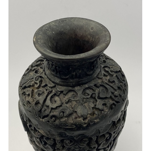 91 - A CHINESE CARVED BLACK CINNABAR LACQUER VASE, the body decorated with incised dragon and smoke motif... 