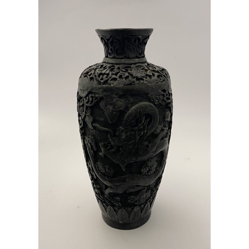 91 - A CHINESE CARVED BLACK CINNABAR LACQUER VASE, the body decorated with incised dragon and smoke motif... 