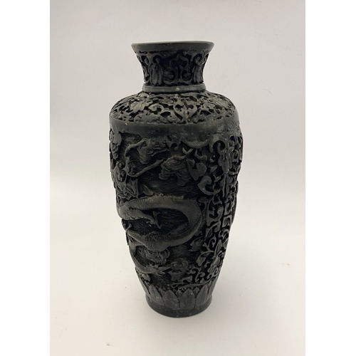 91 - A CHINESE CARVED BLACK CINNABAR LACQUER VASE, the body decorated with incised dragon and smoke motif... 