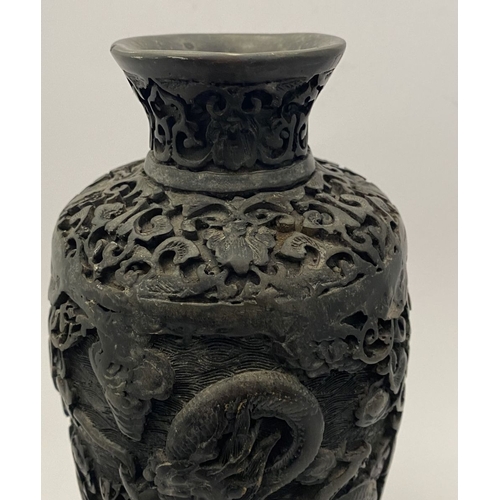 91 - A CHINESE CARVED BLACK CINNABAR LACQUER VASE, the body decorated with incised dragon and smoke motif... 