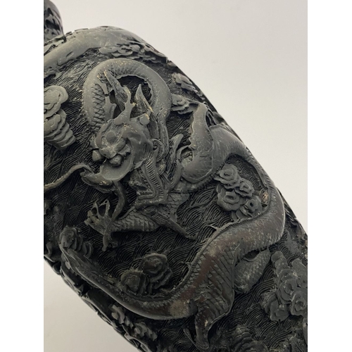 91 - A CHINESE CARVED BLACK CINNABAR LACQUER VASE, the body decorated with incised dragon and smoke motif... 