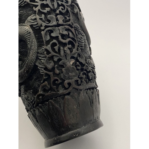 91 - A CHINESE CARVED BLACK CINNABAR LACQUER VASE, the body decorated with incised dragon and smoke motif... 