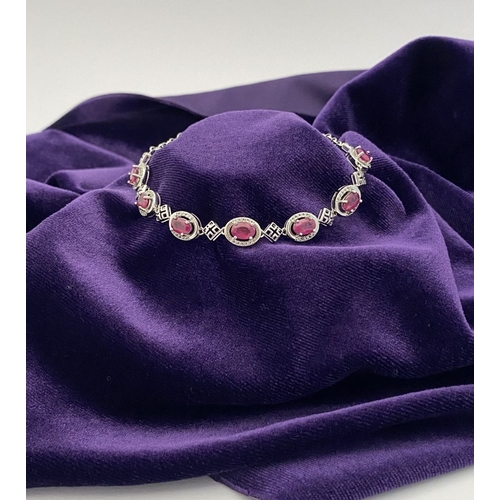 18 - AN ELEGANT 18CT GOLD PLATED RUBY BRACELET, featuring seven oval cut rubies, clarity enhanced for exc... 
