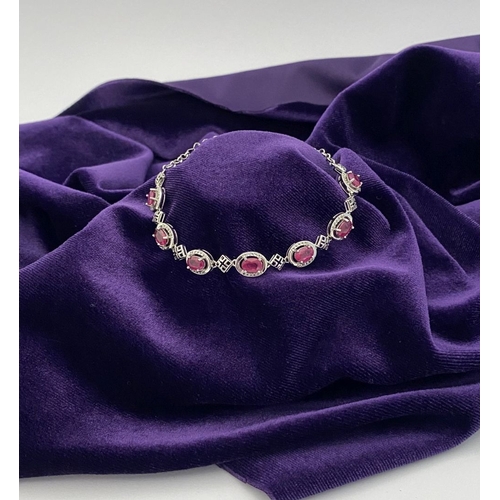 18 - AN ELEGANT 18CT GOLD PLATED RUBY BRACELET, featuring seven oval cut rubies, clarity enhanced for exc... 