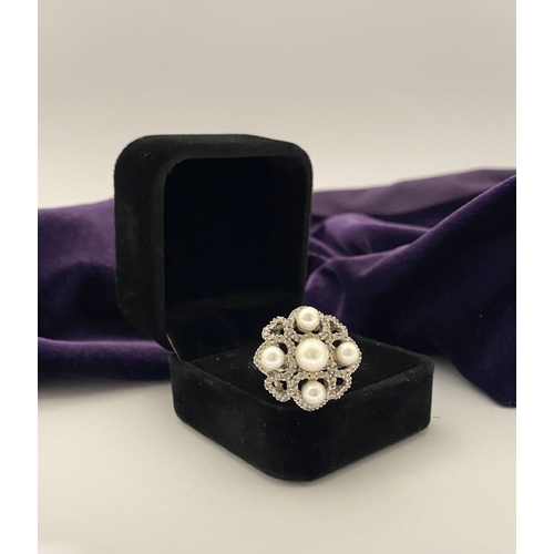 20 - AN ORNATE 9CT WHITE GOLD PEARL & DIAMOND STATEMENT RING, featuring five pearls on white gold setting... 