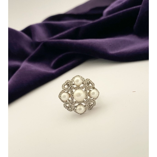 20 - AN ORNATE 9CT WHITE GOLD PEARL & DIAMOND STATEMENT RING, featuring five pearls on white gold setting... 