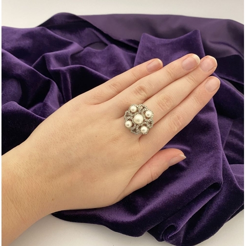 20 - AN ORNATE 9CT WHITE GOLD PEARL & DIAMOND STATEMENT RING, featuring five pearls on white gold setting... 