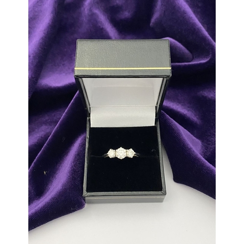 22 - A STUNNING PLATINUM THREE STONE DIAMOND RING, with three beautiful quality natural round brilliant c... 