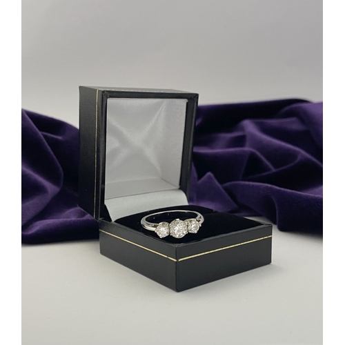 22 - A STUNNING PLATINUM THREE STONE DIAMOND RING, with three beautiful quality natural round brilliant c... 