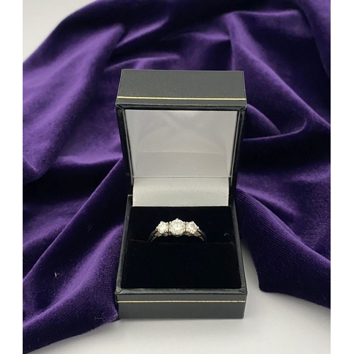 22 - A STUNNING PLATINUM THREE STONE DIAMOND RING, with three beautiful quality natural round brilliant c... 