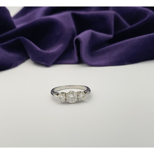 22 - A STUNNING PLATINUM THREE STONE DIAMOND RING, with three beautiful quality natural round brilliant c... 