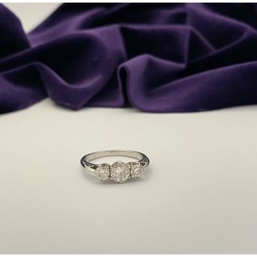 22 - A STUNNING PLATINUM THREE STONE DIAMOND RING, with three beautiful quality natural round brilliant c... 