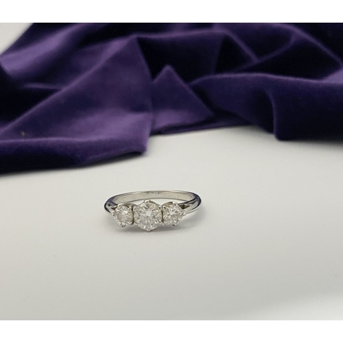 22 - A STUNNING PLATINUM THREE STONE DIAMOND RING, with three beautiful quality natural round brilliant c... 