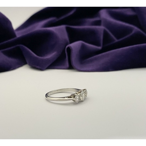 22 - A STUNNING PLATINUM THREE STONE DIAMOND RING, with three beautiful quality natural round brilliant c... 