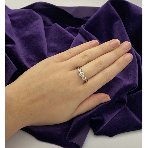22 - A STUNNING PLATINUM THREE STONE DIAMOND RING, with three beautiful quality natural round brilliant c... 