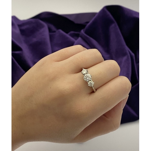 22 - A STUNNING PLATINUM THREE STONE DIAMOND RING, with three beautiful quality natural round brilliant c... 