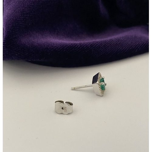 27 - A STUNNING PAIR OF 14CT WHITE GOLD EMERALD & DIAMOND STUD EARRINGS, with central vibrant emerald in ... 