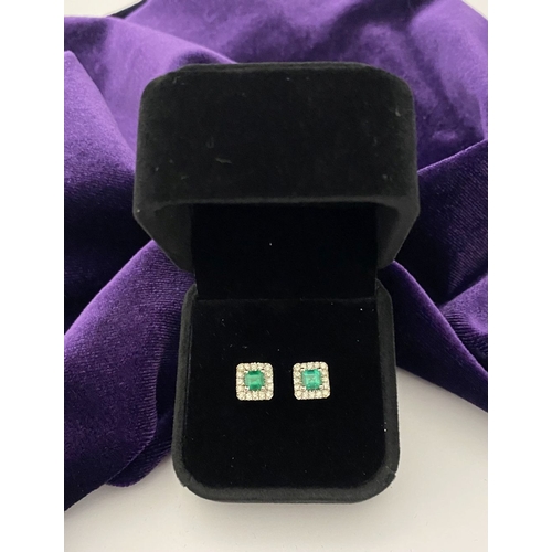 27 - A STUNNING PAIR OF 14CT WHITE GOLD EMERALD & DIAMOND STUD EARRINGS, with central vibrant emerald in ... 