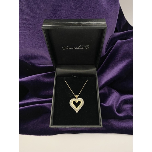 31 - A STUNNING 10CT YELLOW GOLD WHITE SAPPHIRE HEART PENDANT NECKLACE, the heart shaped pendant set with... 