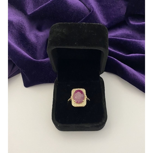 4 - A MAGNIFICENT 14CT GOLD RUBY & DIAMOND STATEMENT RING, with central 6.65ct oval mixed cut ruby, claw... 