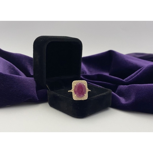 4 - A MAGNIFICENT 14CT GOLD RUBY & DIAMOND STATEMENT RING, with central 6.65ct oval mixed cut ruby, claw... 
