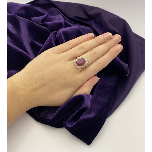 4 - A MAGNIFICENT 14CT GOLD RUBY & DIAMOND STATEMENT RING, with central 6.65ct oval mixed cut ruby, claw... 