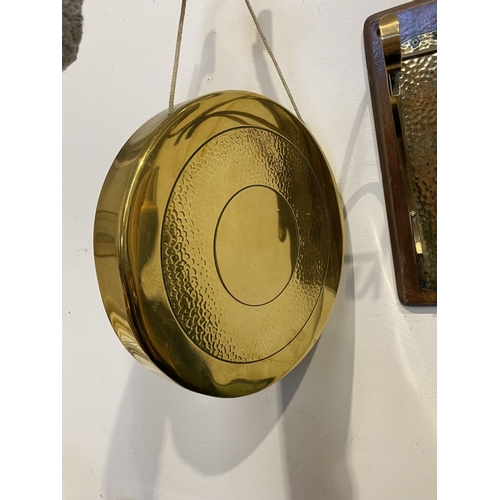 46 - A BRASS WALL HANGING DINNER GONG, wall mountable hardwood stand, with brass hanging hooks and hammer... 