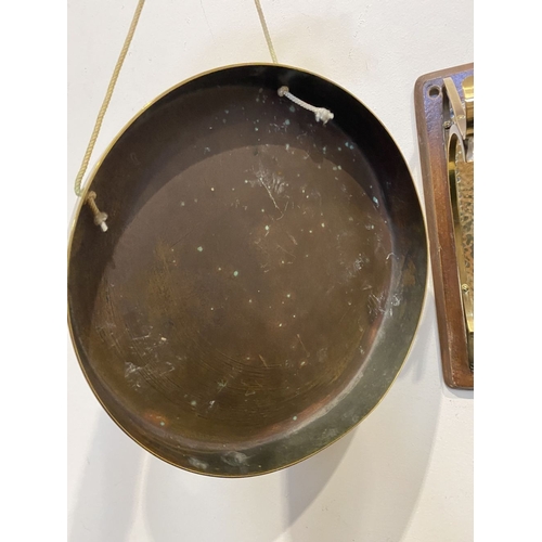 46 - A BRASS WALL HANGING DINNER GONG, wall mountable hardwood stand, with brass hanging hooks and hammer... 