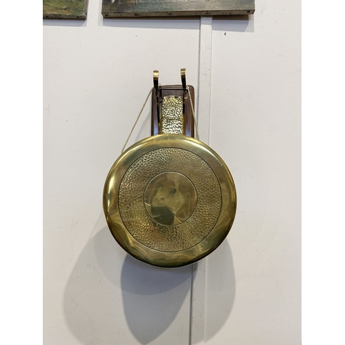 46 - A BRASS WALL HANGING DINNER GONG, wall mountable hardwood stand, with brass hanging hooks and hammer... 