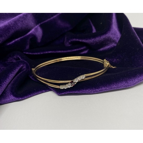 60 - A BEAUTIFUL GOLD GARNET BRACELET, with central round cut vibrant garnet flanked by six round cut cle... 