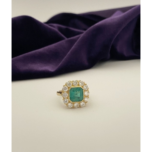 9 - AN EXCEPTIONAL 18CT GOLD EMERALD & DIAMOND CLUSTER RING, with central vibrant emerald in bezel setti... 