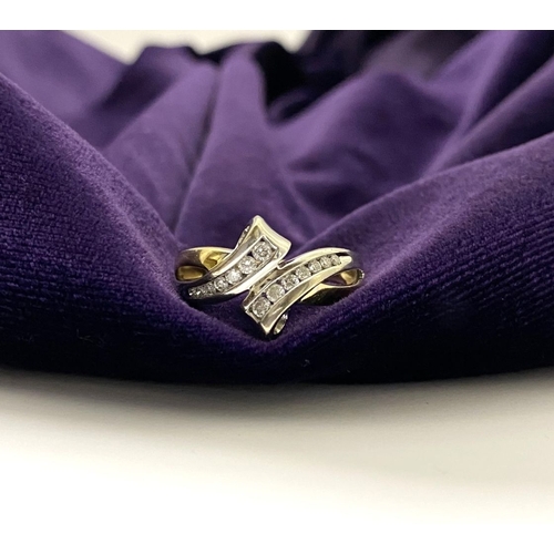 131 - A BEAUTIFUL TWO-TONE 14CT GOLD DIAMOND BYPASS RING, set with fourteen brilliant round cut diamonds, ... 
