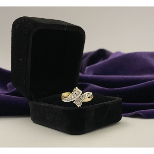 131 - A BEAUTIFUL TWO-TONE 14CT GOLD DIAMOND BYPASS RING, set with fourteen brilliant round cut diamonds, ... 