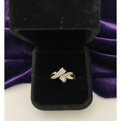 131 - A BEAUTIFUL TWO-TONE 14CT GOLD DIAMOND BYPASS RING, set with fourteen brilliant round cut diamonds, ... 