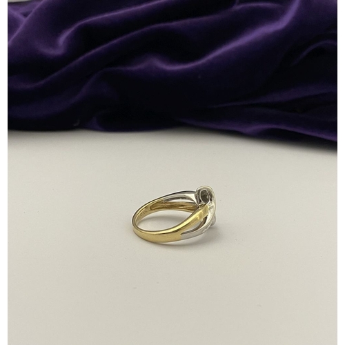 131 - A BEAUTIFUL TWO-TONE 14CT GOLD DIAMOND BYPASS RING, set with fourteen brilliant round cut diamonds, ... 