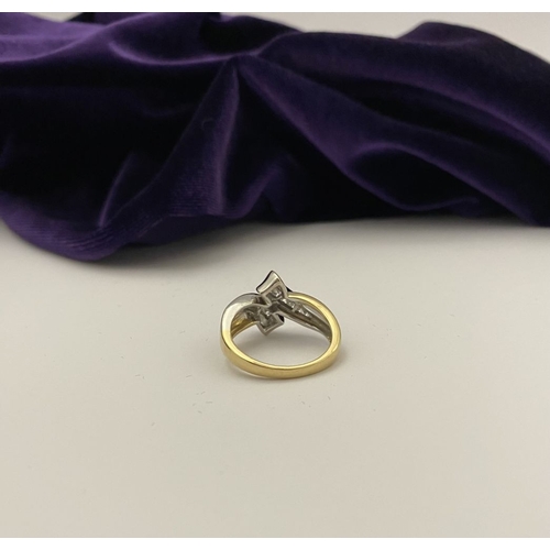 131 - A BEAUTIFUL TWO-TONE 14CT GOLD DIAMOND BYPASS RING, set with fourteen brilliant round cut diamonds, ... 