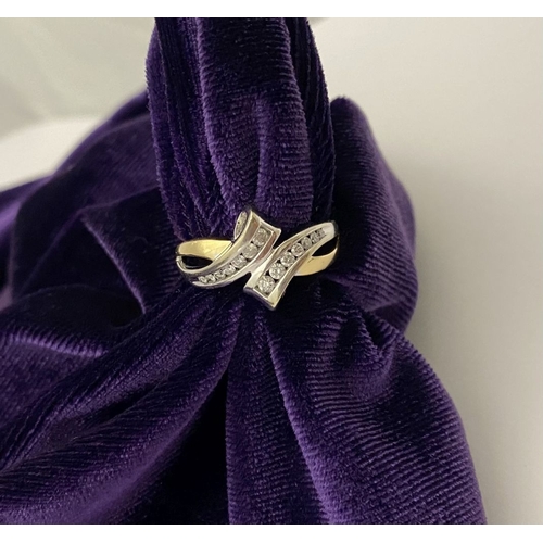131 - A BEAUTIFUL TWO-TONE 14CT GOLD DIAMOND BYPASS RING, set with fourteen brilliant round cut diamonds, ... 