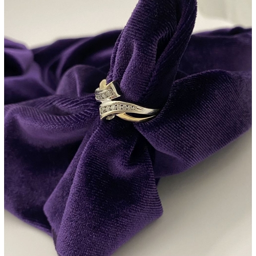 131 - A BEAUTIFUL TWO-TONE 14CT GOLD DIAMOND BYPASS RING, set with fourteen brilliant round cut diamonds, ... 