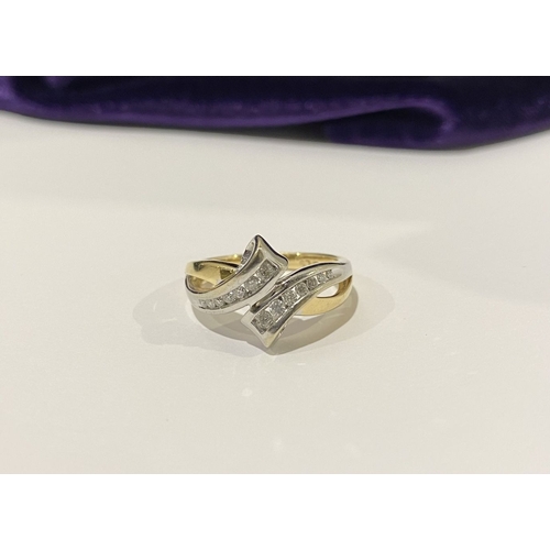 131 - A BEAUTIFUL TWO-TONE 14CT GOLD DIAMOND BYPASS RING, set with fourteen brilliant round cut diamonds, ... 