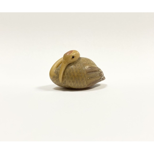 79 - AN ANTIQUE HAND CARVED JAPANESE TAGUA NUT NETSUKE, in the form of a crane, signed to base. Intricate... 