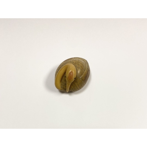 79 - AN ANTIQUE HAND CARVED JAPANESE TAGUA NUT NETSUKE, in the form of a crane, signed to base. Intricate... 