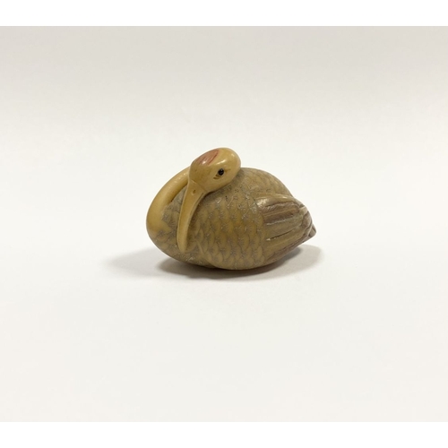 79 - AN ANTIQUE HAND CARVED JAPANESE TAGUA NUT NETSUKE, in the form of a crane, signed to base. Intricate... 