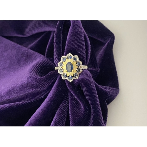 30 - A BEAUTIFUL 18CT GOLD PLATED NATURAL SAPPHIRE CLUSTER RING, featuring central oval cut sapphire, sur... 