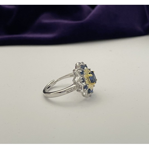30 - A BEAUTIFUL 18CT GOLD PLATED NATURAL SAPPHIRE CLUSTER RING, featuring central oval cut sapphire, sur... 