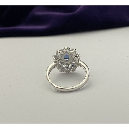 30 - A BEAUTIFUL 18CT GOLD PLATED NATURAL SAPPHIRE CLUSTER RING, featuring central oval cut sapphire, sur... 