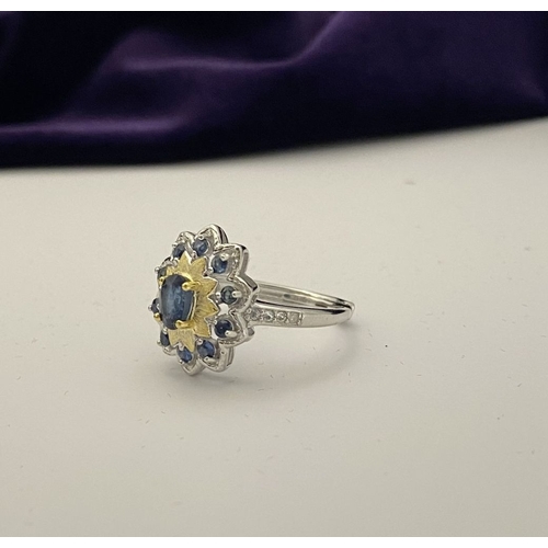 30 - A BEAUTIFUL 18CT GOLD PLATED NATURAL SAPPHIRE CLUSTER RING, featuring central oval cut sapphire, sur... 
