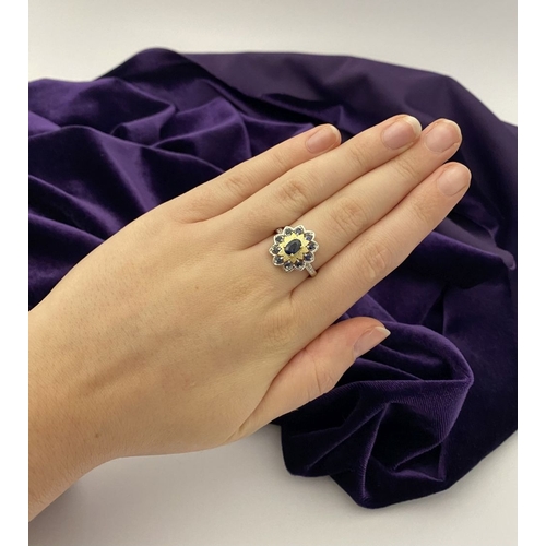 30 - A BEAUTIFUL 18CT GOLD PLATED NATURAL SAPPHIRE CLUSTER RING, featuring central oval cut sapphire, sur... 