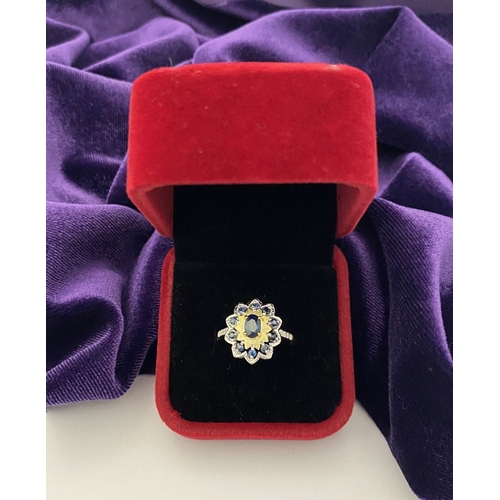 30 - A BEAUTIFUL 18CT GOLD PLATED NATURAL SAPPHIRE CLUSTER RING, featuring central oval cut sapphire, sur... 